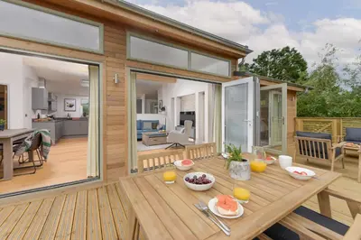 a wooden deck with a table with food on it at 5 Southern Place in Liskeard