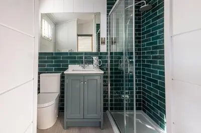 a bathroom with a sink and a toilet and a mirror at Gull Rocks Beach Lodges in Cubert