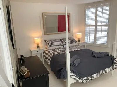 a bedroom with a bunk bed and a mirror at Luxurious cottage in the heart of Falmouth in Falmouth