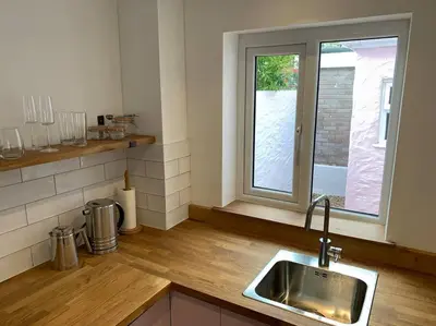 a kitchen with a sink and a window at Luxurious cottage in the heart of Falmouth in Falmouth
