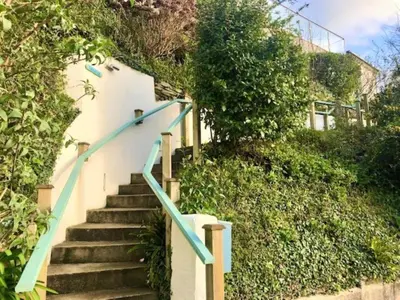 a set of stairs leading up to a house at 2 Bed in Torpoint oc-75402 in Downderry