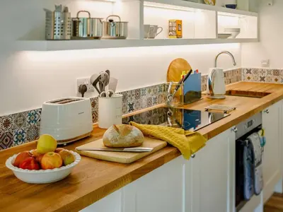 a kitchen counter with a bowl of fruit on it at 1 Bed in Looe oc-88434 in Lanreath