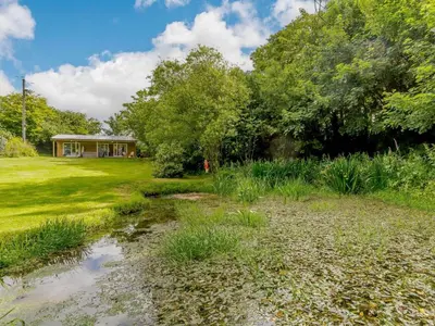 a garden with a house in the background at 1 Bed in Looe oc-88434 in Lanreath