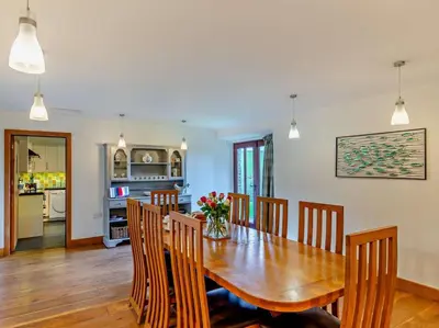 a dining room with a wooden table and chairs at 4 Bed in Boscastle oc-47035 in Boscastle