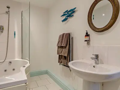 a white bathroom with a sink and a mirror at 4 Bed in Boscastle oc-47035 in Boscastle