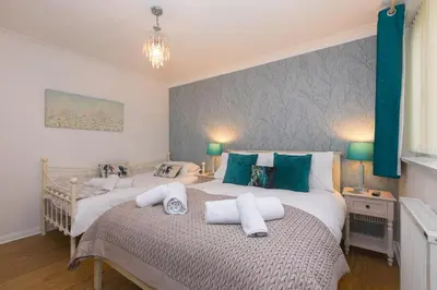 a bedroom with two beds with towels on them at Ocean Edge in St Ives