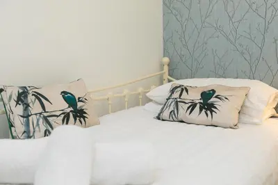 a bedroom with a bed with two pillows on it at Ocean Edge in St Ives