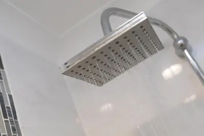a shower head with rain on it in a bathroom at Ocean Edge in St Ives