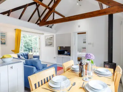 a living room with a table and a blue couch at 2 Bed in Penryn oc-78621 in Penryn