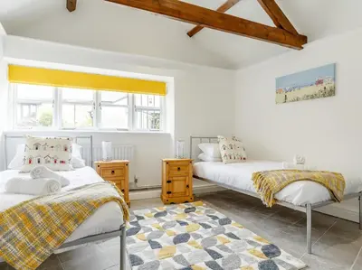 two beds in a room with white walls and windows at 2 Bed in Penryn oc-78621 in Penryn