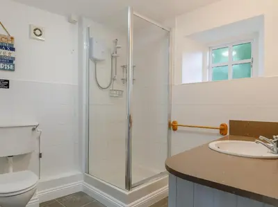 a bathroom with a shower and a toilet and a sink at 2 Bed in Penryn oc-78621 in Penryn