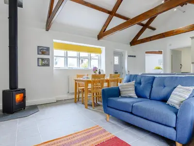 a living room with a blue couch and a stove at 2 Bed in Penryn oc-78621 in Penryn