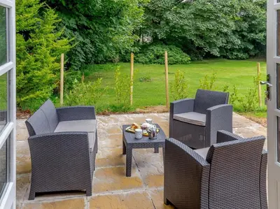 a patio with two chairs and a table with a table at 2 Bed in Penryn oc-78621 in Penryn