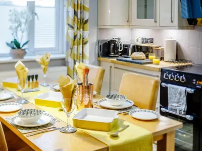 a kitchen with a table with plates and glasses on it at 2 Bed in Redruth oc-86269 in Gwennap