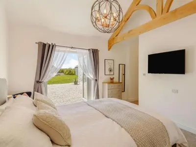 a bedroom with a bed and a tv and a window at 3 Bed in Redruth oc-88102 in Redruth