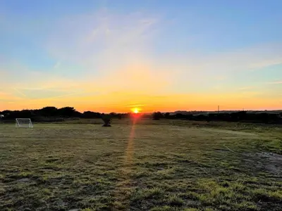 a sunset in a field with a soccer ball at 3 Bed in Redruth oc-88102 in Redruth