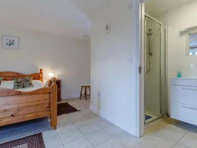 a bedroom with a bed and a walk in shower at 2 Bed in Truro oc-ljasm in Saint Allen