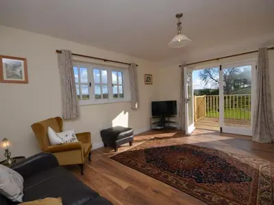 a living room with a couch and a chair at 2 Bed in Truro oc-ljasm in Saint Allen