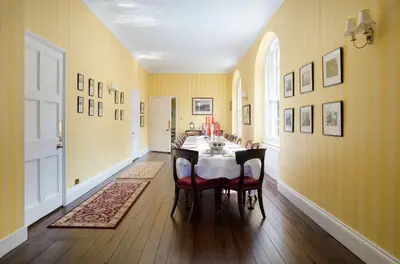 a dining room with a table and chairs at Catchfrench Manor in Sheviock