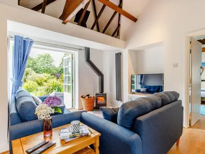 a living room with two blue couches and a table at 2 Bed in Penryn oc-78620 in Penryn