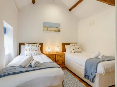 two beds in a room with white walls at 2 Bed in Penryn oc-78620 in Penryn