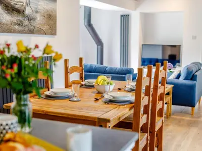 a dining room with a wooden table and chairs at 2 Bed in Penryn oc-78620 in Penryn