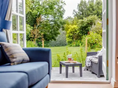 a living room with a blue couch and a table at 2 Bed in Penryn oc-78620 in Penryn