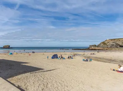 a group of people sitting on a beach at 2 Bed in Redruth oc-sanap in Portreath