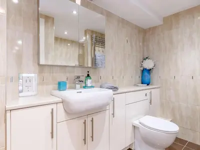 a bathroom with a white sink and a toilet at 2 Bed in Redruth oc-sanap in Portreath