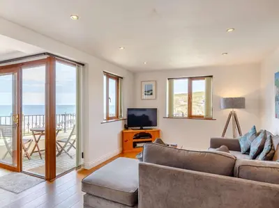 a living room with a couch and a television at 2 Bed in Redruth oc-sanap in Portreath