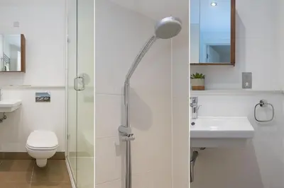 a bathroom with a shower with a toilet and a sink at Number One Peninsula in St Ives