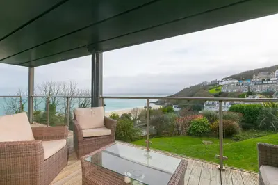 a balcony with a view of the ocean at Number One Peninsula in St Ives