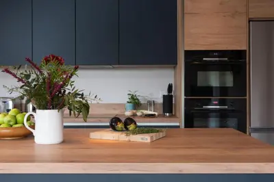 a kitchen with a counter with a vase of flowers on it at Beachside in Newquay