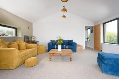 a living room with couches and a coffee table at Beachside in Newquay