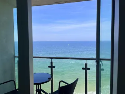 a view of the ocean from a room with a table and chairs at Newquay Rocklands Beach View in Newquay