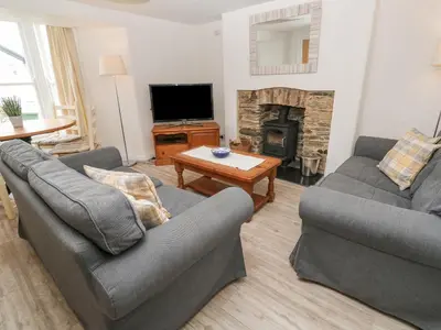 a living room with two couches and a fireplace at Kelsey in Truro