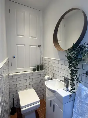 a bathroom with a white toilet and a mirror at Aggie Beach Apartment - Unrivalled Beach Views in St. Agnes