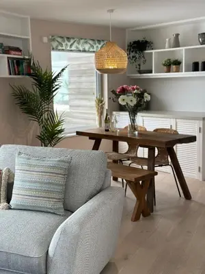 a living room with a table and a couch at Aggie Beach Apartment - Unrivalled Beach Views in St. Agnes