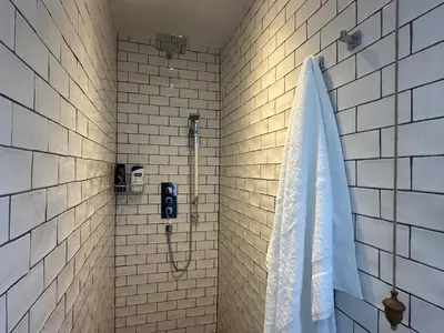 a bathroom with a shower with a shower curtain at Aggie Beach Apartment - Unrivalled Beach Views in St. Agnes