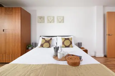 a bedroom with a large bed with a basket on it at 10 Bredon Court - Close to Town & Beaches - Free Parking & WiFi - Sea View in Newquay