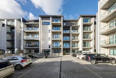 a parking lot with cars parked in front of a building at 1 Cliff Edge in Newquay in Newquay