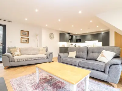 a living room with two couches and a coffee table at Wildwood in Newquay
