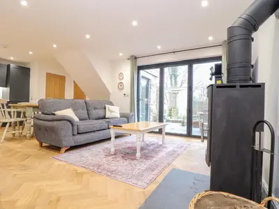 a living room with a couch and a stove at Wildwood in Newquay