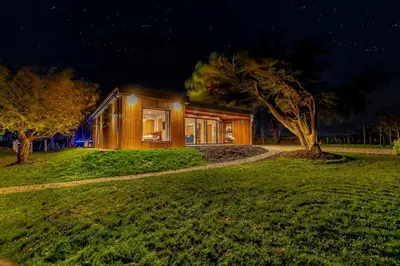 a house with a tree in front of it at Luxury holiday home near the coast in Porthtowan