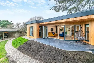 a house with glass doors and a patio at Luxury holiday home near the coast in Porthtowan