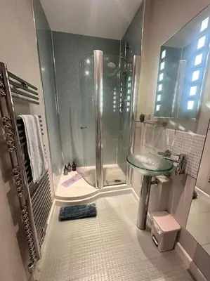 a bathroom with a shower and a sink at The Surf House (Widemouth Bay) in Bude