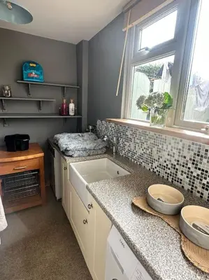 a bathroom with a sink and a window at The Surf House (Widemouth Bay) in Bude