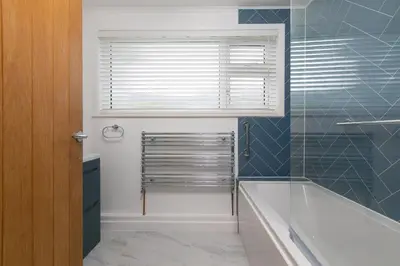 a bathroom with a bath tub and a window at Ocean Aura in Carbis Bay