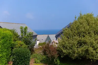 a row of houses with trees and bushes at Ocean Aura in Carbis Bay
