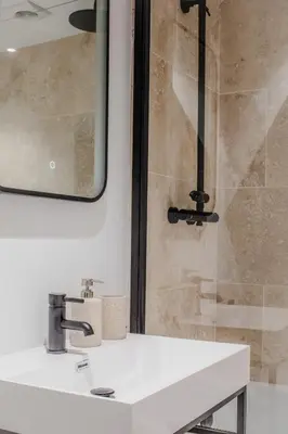 a bathroom with a sink and a shower at Lowen Tree House in Truro